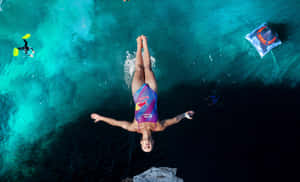 Adventure-seeking Climber Scaling A Steep Cliff Wallpaper