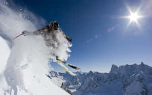 Adventurous Soul Conquering The Pristine White Slopes Wallpaper