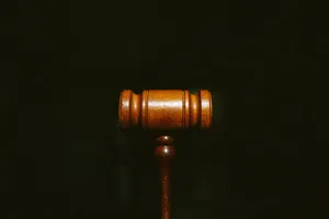 Advocate Wooden Gavel In Solid Black Wallpaper