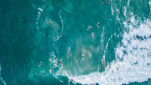 Aerial Surfers Riding Waves Wallpaper