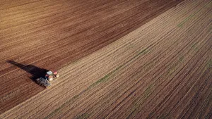 Aerial View Of Tractor Working In Field Wallpaper
