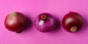 Aesthetic Arrangement Of Red Onions Wallpaper