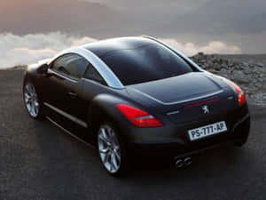 Aesthetic Shots Of A Black Peugeot Rcz Under City Lights Wallpaper