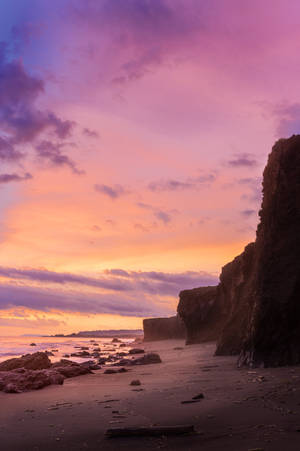 Aesthetic Sky Above Seaside Rocks Wallpaper