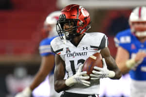 Ahmad Gardner Of Cincinnati Bearcats Strides With An Interception Wallpaper