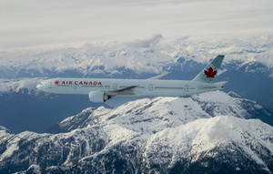 Air Canada Airplane Over Snowy Mountain Wallpaper