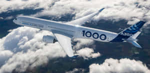 Airbus A3501000 Midflight Over Clouds Wallpaper