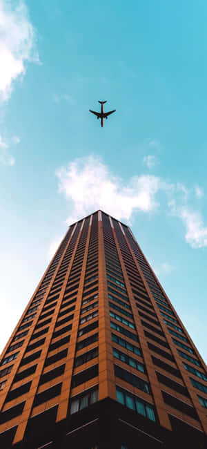 Airplane_ Over_ Skyscraper Wallpaper