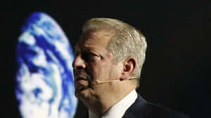 Al Gore Standing With Picture Of Earth Wallpaper