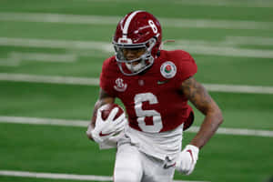 Alabama Football Player Running With Ball Wallpaper