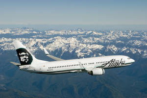 Alaska Airlines Flying Above The Alps Wallpaper