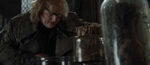 Alastor Moody Examining Magical Objects Wallpaper