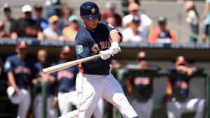 Alex Bregman Swinging Bat In Front Of Players Wallpaper