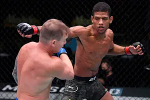 Alex Caceres Punching Austin Springer Wallpaper