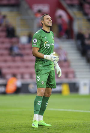 Alex Mccarthy At A Football Stadium Wallpaper