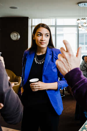 Alexandria Ocasio-cortez In A Blue Blazer Wallpaper