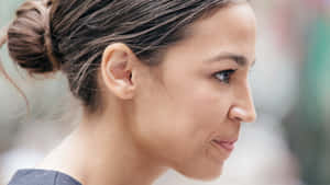 Alexandria Ocasio-cortez In A Thoughtful Look Wallpaper