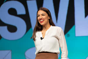 Alexandria Ocasio-cortez With A Blue Backdrop Wallpaper