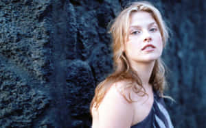 Ali Larter Posing Against A Rock Wallpaper