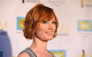 Alicia Witt Posing Elegantly In A Stunning Red Dress Wallpaper