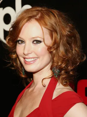 Alicia Witt Smiling In Red Outfit Wallpaper
