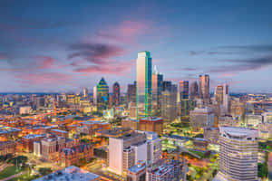 Alluring Aerial View Of Dallas Cityscape At Sunset Wallpaper