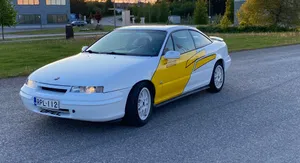 Alluring Beauty Of Opel Calibra In Maroon Wallpaper