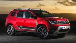 Alluring Dacia Car On Picturesque Mountain Road Wallpaper