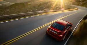 Alluring Nissan Maxima In Urban Landscape Wallpaper