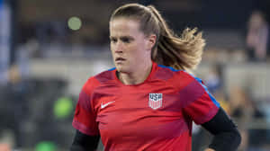 Alyssa Naeher In Action During A Soccer Match Wallpaper