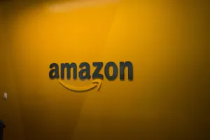 Amazon Uk Logo In Yellow-orange Wall Wallpaper