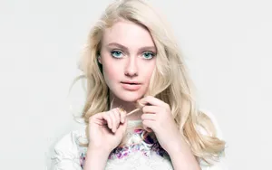 American Actress Dakota Fanning Twisting Hair Pose Wallpaper