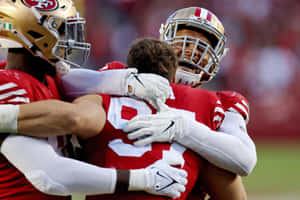 American Defensive Lineman Arik Armstead Hugging Nick Bosa Wallpaper