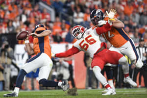 American Footballer Garett Bolles Guarding His Opponent Wallpaper