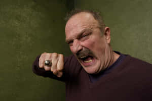 American Wrestler Jake Roberts Posing In The Village At The Lift Wallpaper