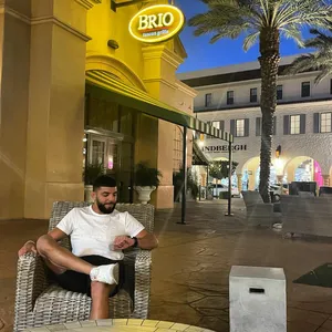 Amir Albazi Looking At Watch Wallpaper