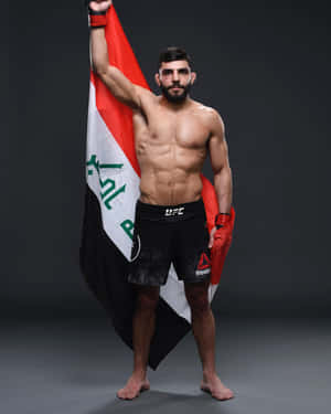 Amir Albazi Proudly Raising The Iraqi Flag Wallpaper