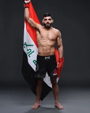 Amir Albazi Proudly Raising The Iraqi Flag Wallpaper
