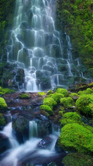 An Aerial View Of A Beautiful Waterfall Cascading Into A Magnificent Lake Wallpaper