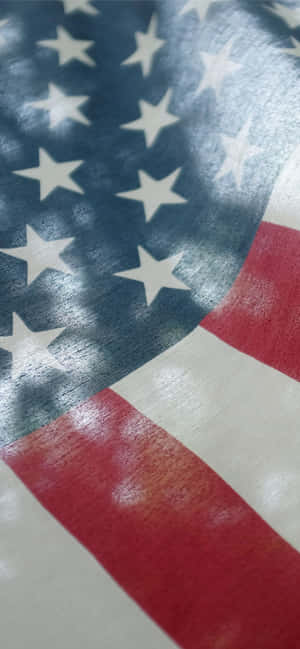 An American Flag With Sunlight Shining On It Wallpaper