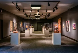 An Array Of Art Pieces On Display At An Exhibition Wallpaper
