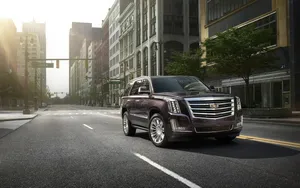 An Elegant Cadillac Escalade On The Road Wallpaper