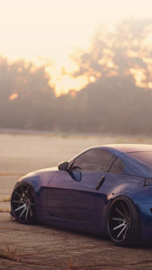 An Eye-catching Nissan 350z In Silver With A Sleek Iphone Mounted On The Dash. Wallpaper