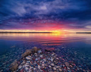 An Inspiring Landscape Of A Sunlit Beach With A Pier. Wallpaper