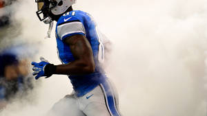 An Intense Action Shot Of A Hard-hitting Detroit Lions Game Wallpaper