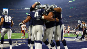 An Intense Moment As An Nfl Quarterback Prepares To Throw A Pass Wallpaper