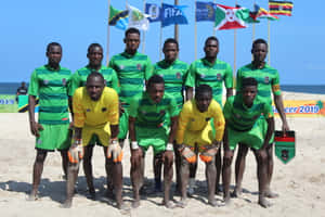 An Intensive Beach Soccer Match At Sunset Wallpaper
