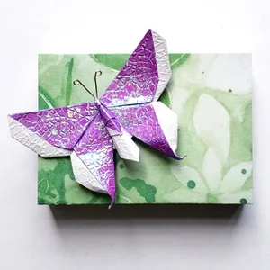 An Intricately Folded Origami Butterfly Illuminated On A Plain White Background. Wallpaper