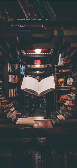 An Open Book On A Shelf In A Bookstore Wallpaper