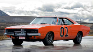 An Orange Dodge Charger Is Parked On The Road Wallpaper